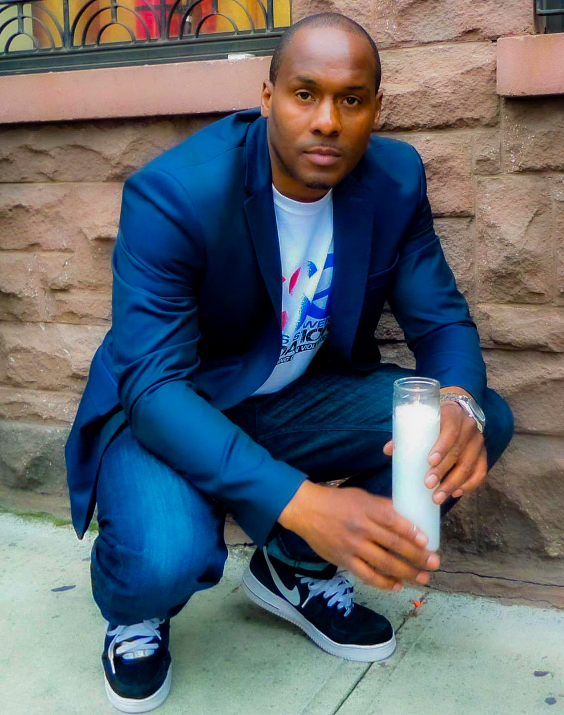 Chris Foye — Founder & Executive Director, The Chris S. Owens Foundation, holding a candle at a vigil